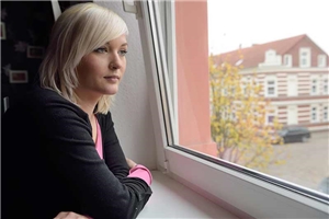 Junge Schwangere am Fenster Junge Frau schaut zum Fenster hinaus