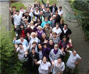 Das Team hat sich zum Gruppenfoto im Garten versammelt. Das Team hat sich zum Gruppenfoto im Garten versammelt.