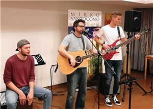 Drei junge Männer singen und machen Musik
