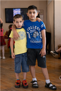 Zwei Jungen, die im Kinder- und Jugendzentrum der Caritas Georgien zusammenstehen und in die Kamera blicken