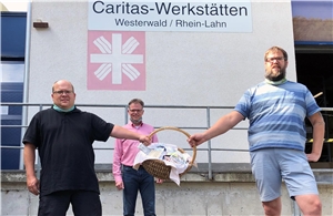 Christian Döring und Björn Flick von Wäller helfen übergeben die 150 Masken an Betriebsleiter Günter Keßler