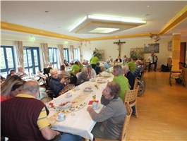 Senioren sitzen an einem langen Tisch als Tafel / Foto: Schedlbauer