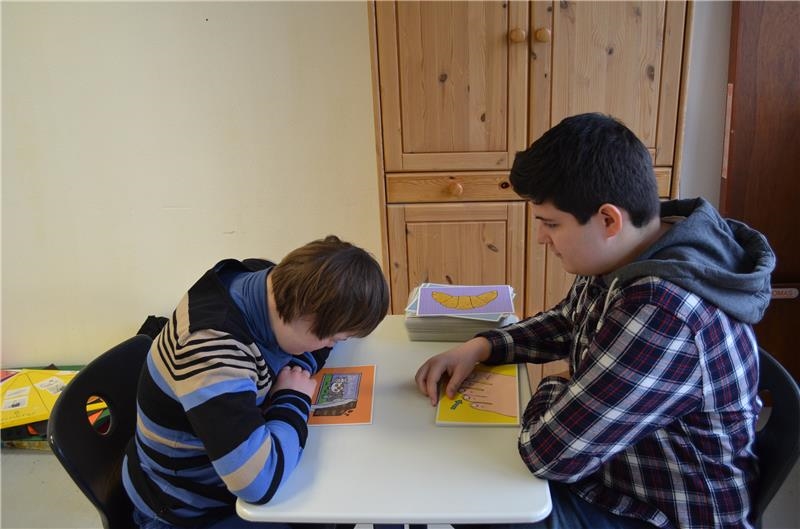 Freiwillgendienstleistende mit Kind und Sprachkarten in der Förderschule (Caritasverband für das Dekanat Bocholt e.V.)