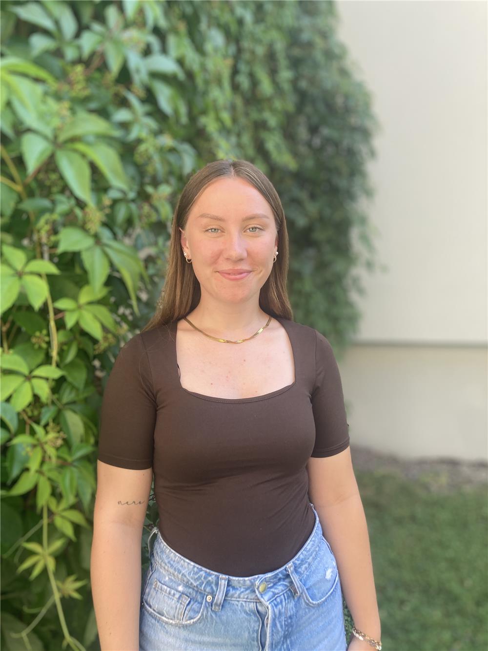 Das Foto zeigt das Gesicht von Jana Fischer vor einem Gebüsch.