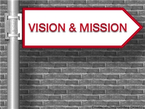 Wegweiser: Bildkollage auf der "VISION & MISSION" in roten Großbuchstaben steht, vor Backsteinwand, in Graustufen. (c) pixabay,com | Nachbearbeitet: Caritas FRG.
