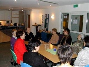 cafekunterbunt Menschen sitzen gemeinsam am Tisch im Café Kunterbunt