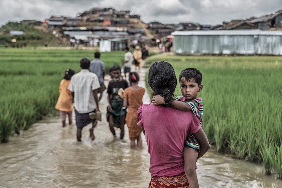Rohingya auf der Flucht: Mann mit Kind auf dem Arm