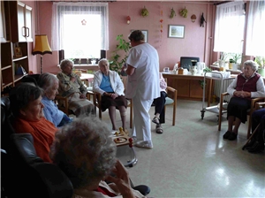 Eine Pflegerin ist im Gespräch mit Bewohnern im Stuhlkreis 