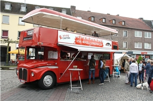 youngcadritas-bus_Streetsoccer-Turnier ein nostalgischer roter Bus an dem das youngcaritas-Banner hängt
