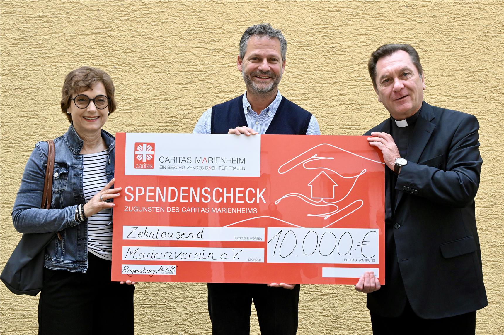Zwei Männer und eine Frau mit einem überdimensional großen Scheck