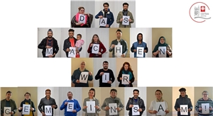 Mitarbeiter:innen des Migrationsdienstes halten die Buchstaben für "Das machen wir gemeinsam"