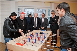 Kardinal Reinhard Marx spielt Tischkicker mit unbegleiteten minderjährigen Flüchtlingen im Alveni-Jugendhaus in München