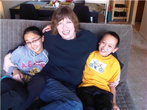 R.B. mit ihren beiden Kindern zuhause auf dem Sofa