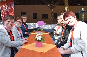 Foto von Teilnehmenden aus Maria Grünewald, die an einem Tisch sitzen