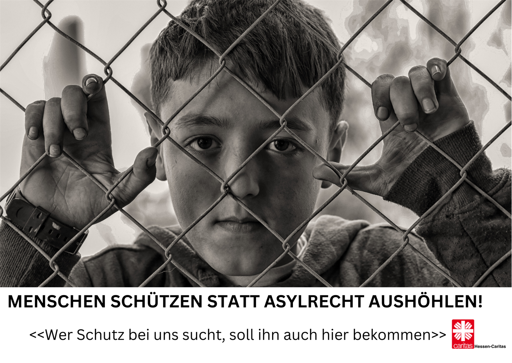 Refugee boy behind a fence