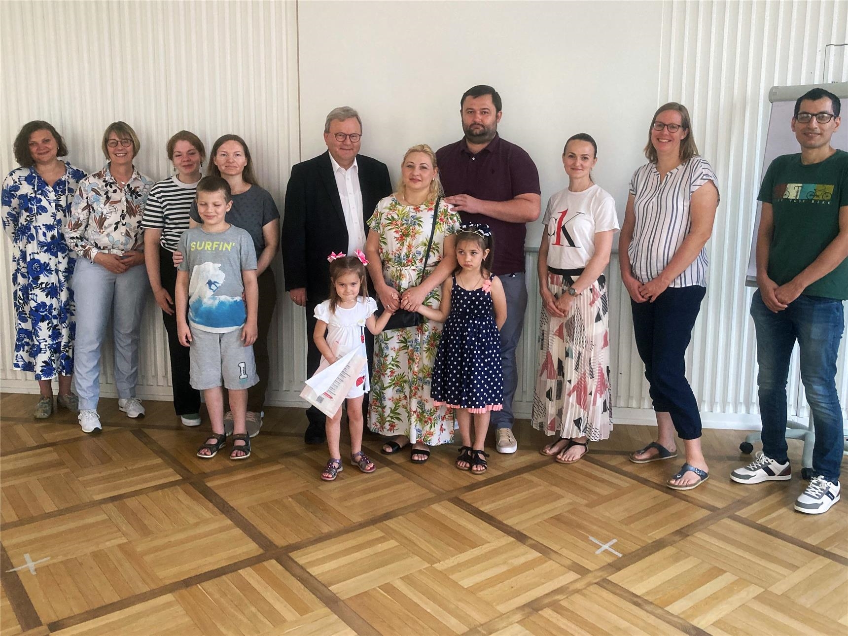 Bischof Franz-Josef Bode (Mitte) mit zwei Familien aus der Ukraine und den Berater*innen des Caritasverbandes.