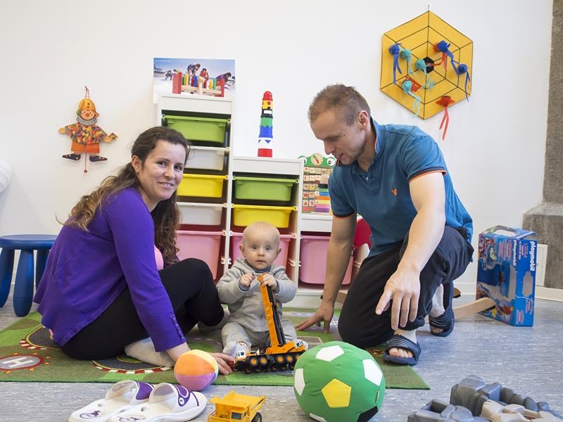 Familie mit Kleinkind im spielt Kinderzimmer (Angela Kröll)