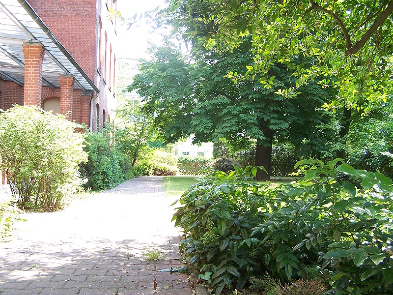 Verwunschener Garten rund um das historische Backsteingebäude. 