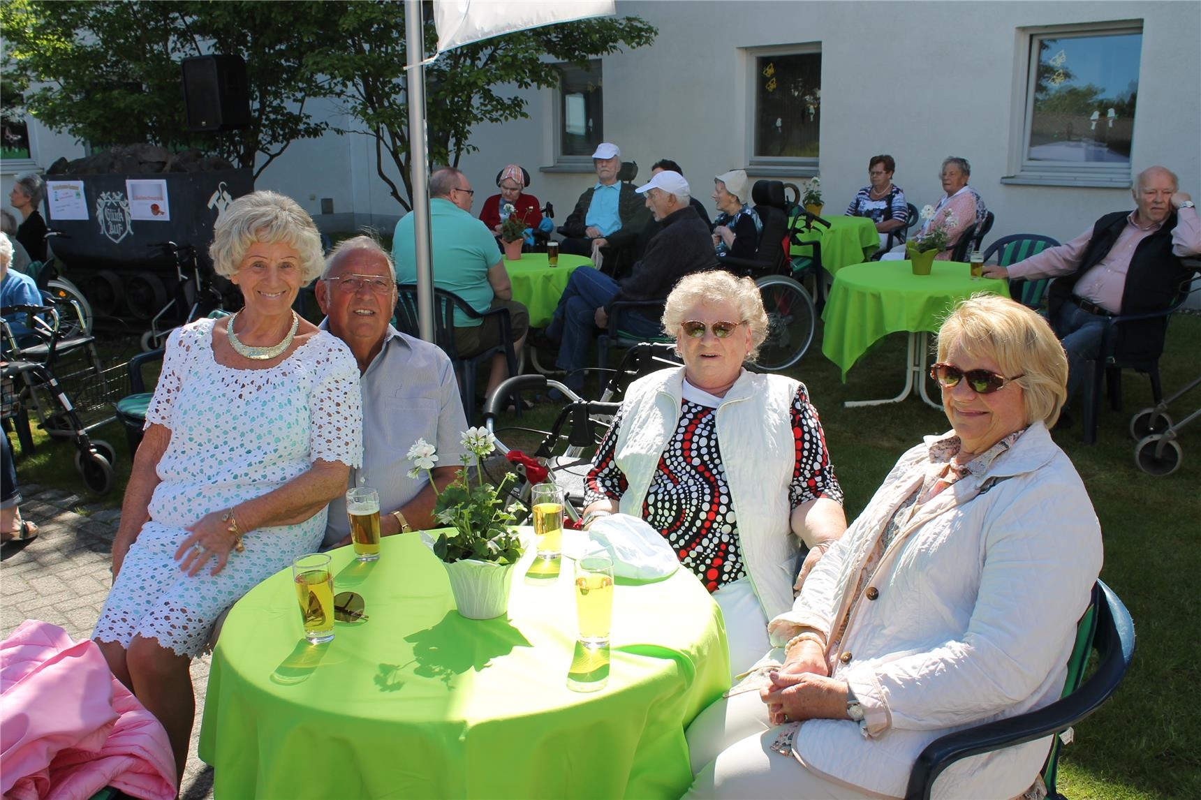Senioren sitzen draußen am Tisch mit Getränken (St. Vinzenz-Vorsterhausen)