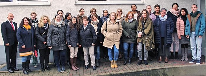 Gruppenbild mit 24 Personen vor Dienstgebäude der Caritas (Caritasverband Darmstadt e. V. / Claudia Betzholz)