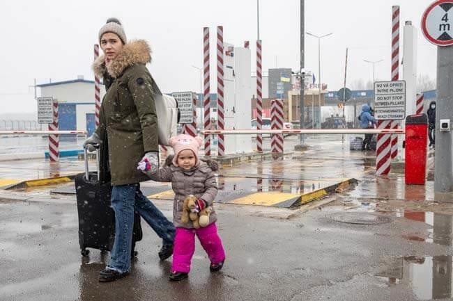 Frau mit kleinem Kind am Grenzübergang (Foto: Marijn Fidder/ Caritas international)