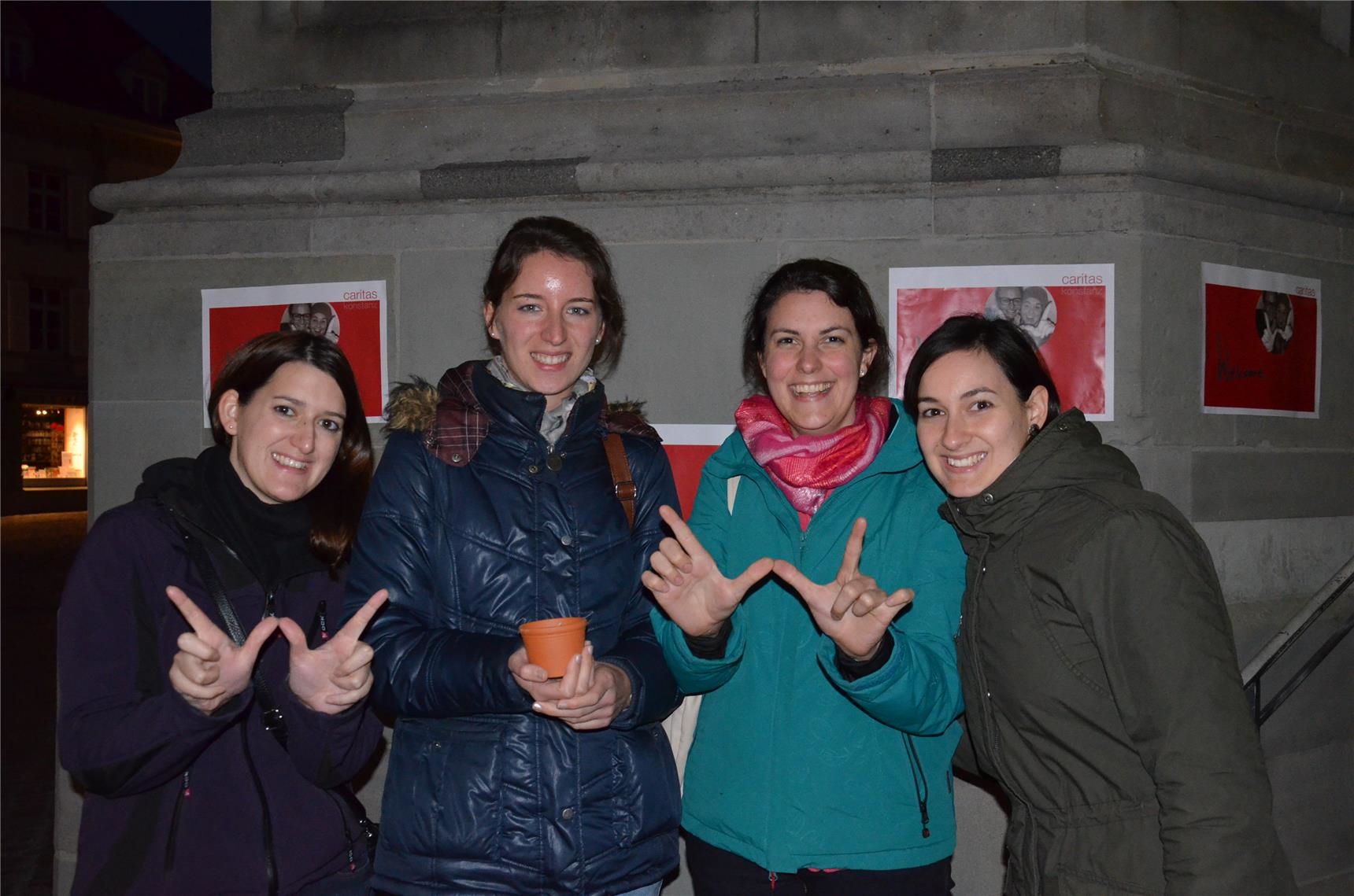 vier junge Frauen mit W-Fingern (Caritas Konstanz)