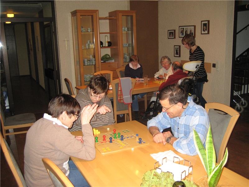 mehrere Personen spielen Gesellschaftsspiele am Esstisch (©caritasverband bocholt)