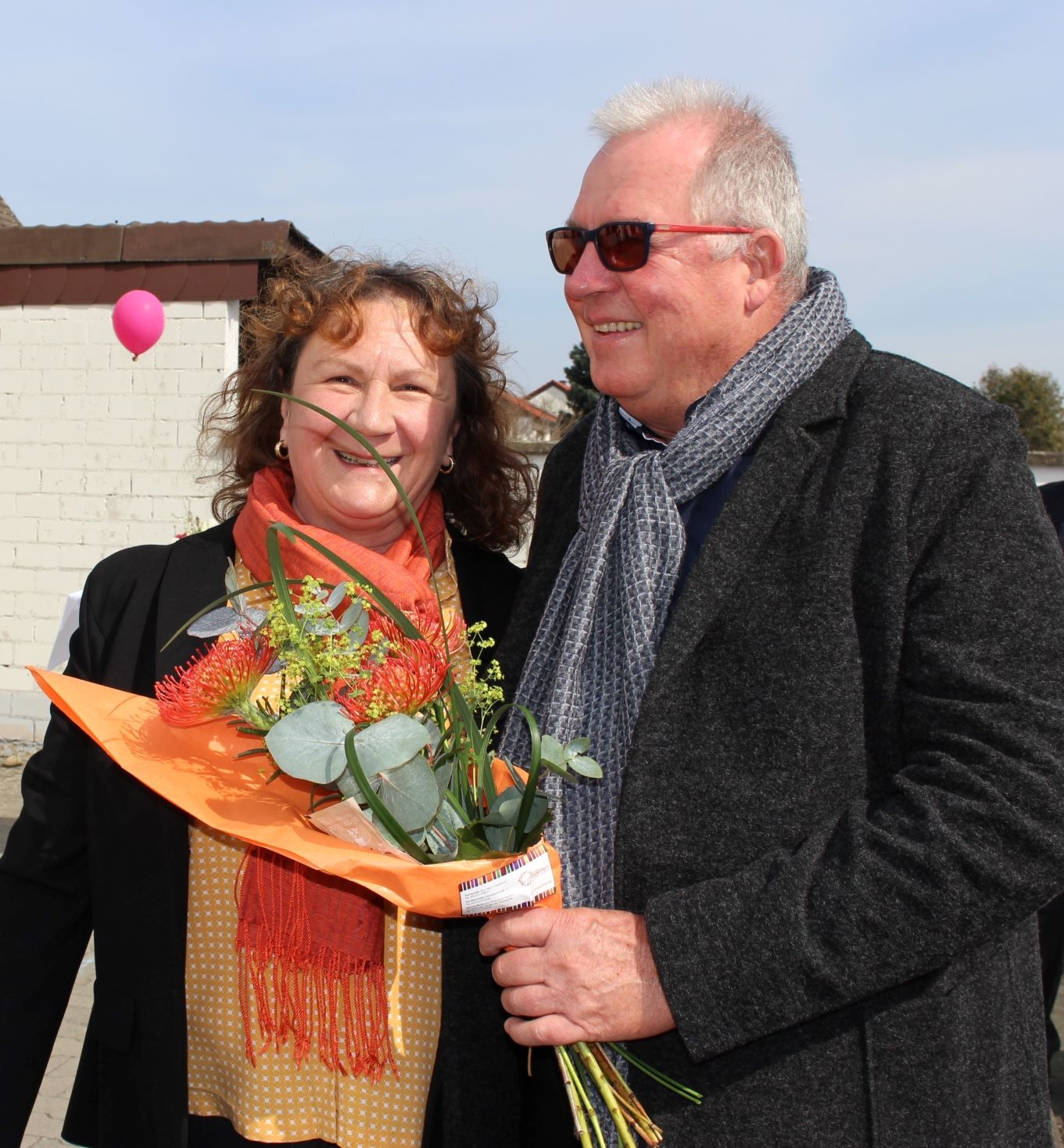 Eine Frau und ein Mann mit einem Blumenstrauß. (Caritasverband Darmstadt e. V.)