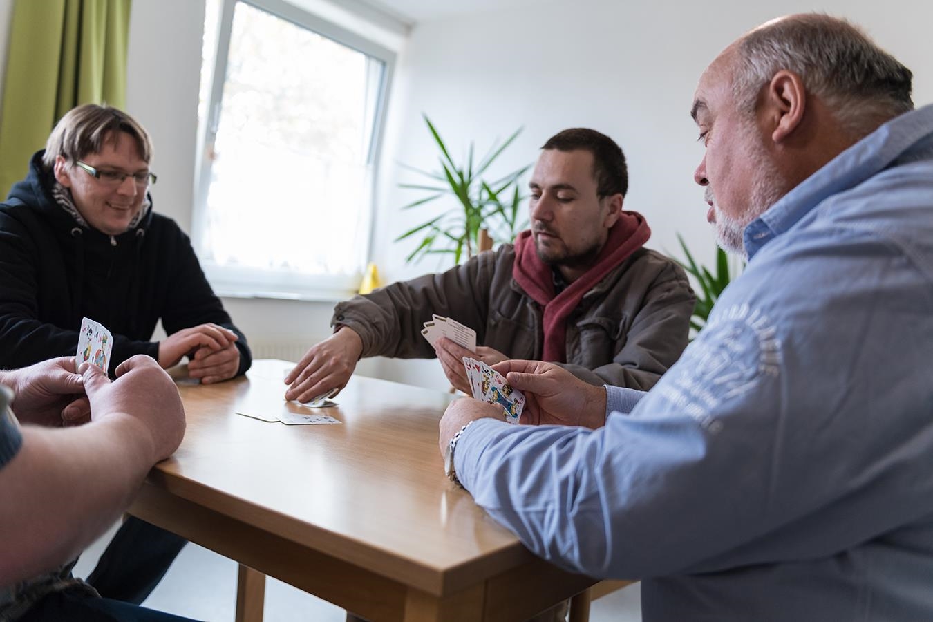wohnungslose Männer beim Karten spielen (Deutscher Caritasverband / Pedro Citoler)