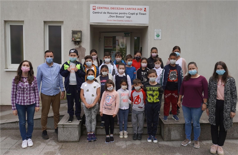 Mehrere Kinder und das Personal des Kinder-und Jugendhilfezentrums Don Bosco stehen vor ihrem Gebäude in Iasi.